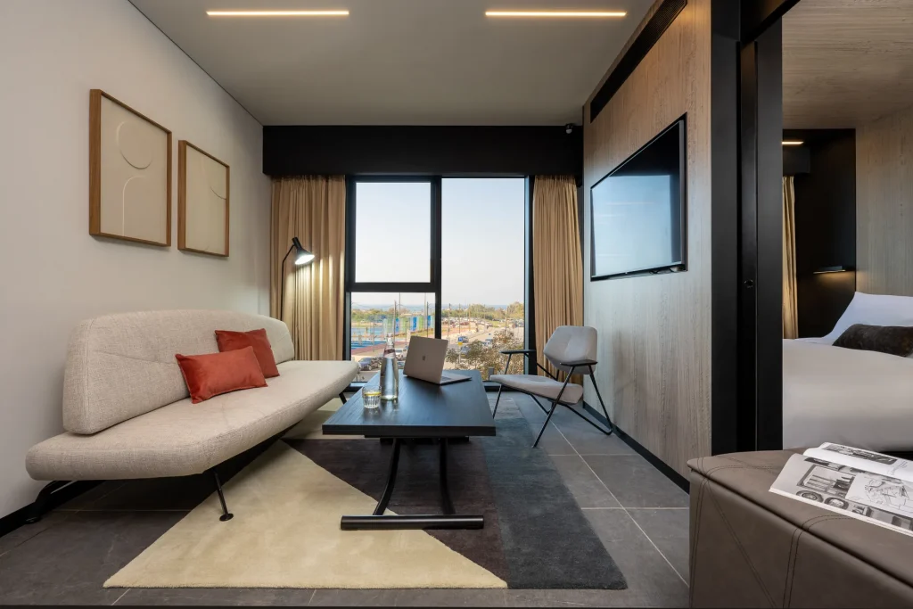 Well-appointed living space in the One-Bedroom Suite with Sofa Bed at master Bat Yam, blending a cozy seating area with contemporary furnishings