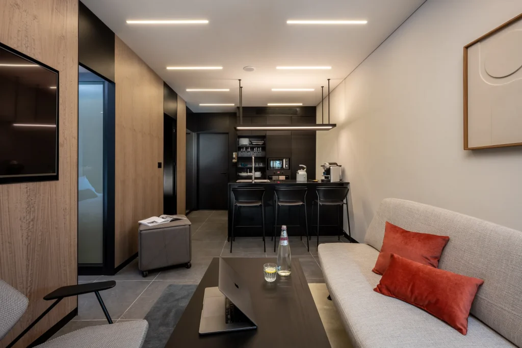 Modern and inviting living room in the One-Bedroom Suite with Sofa Bed at master Bat Yam, showcasing a plush sofa bed in a bright, airy setting.