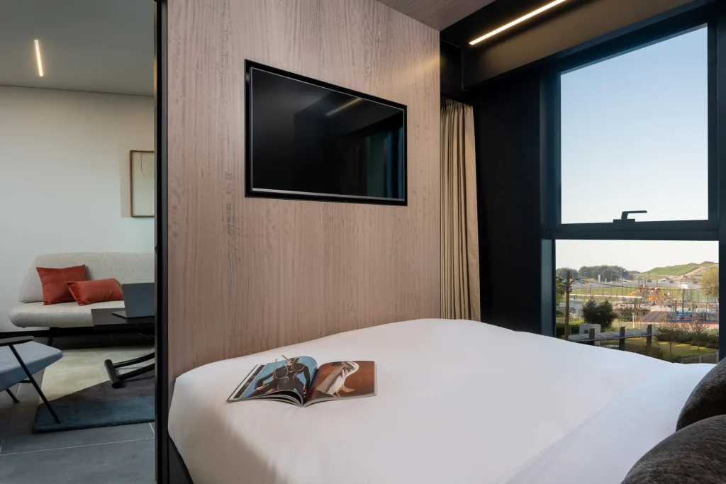 Bright and cozy sleeping area in the One-Bedroom Suite with Sofa Bed at master Bat Yam, designed for a restful stay with soft linens and modern decor.