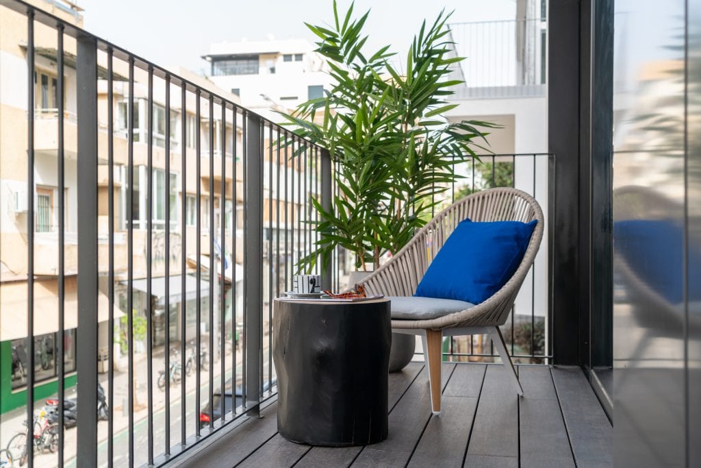 Spacious private balcony in the Three-Bedroom Apartment at master Shenkin Tel Aviv, offering a relaxing outdoor retreat