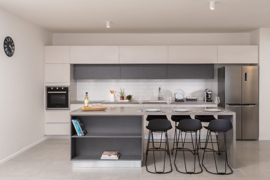 Modern and functional kitchenette in the Three-Bedroom Apartment with Big Terrace at master Shenkin Tel Aviv, designed with sleek cabinetry and high-end appliances.