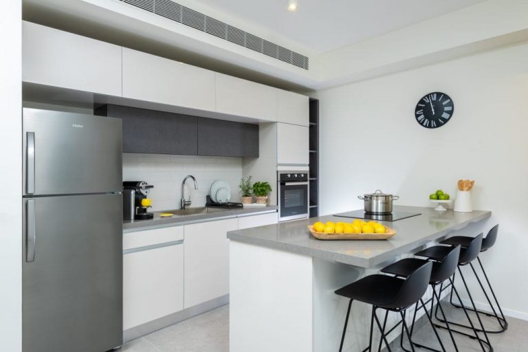 Compact and functional kitchenette in the Two-Bedroom Apartment at master Shenkin Tel Aviv, designed for convenience with modern appliances.