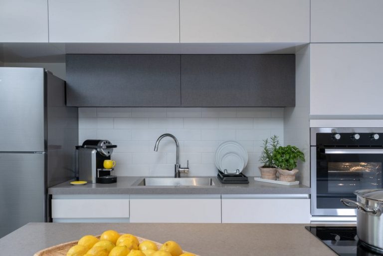 Well-appointed kitchenette in the Two-Bedroom Apartment at master Shenkin Tel Aviv, blending sleek cabinetry with a practical layout