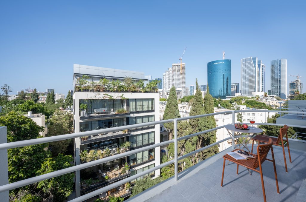 Private balcony at master Mazeh Tel Aviv, offering a scenic view of the surrounding neighborhood and city skyline.