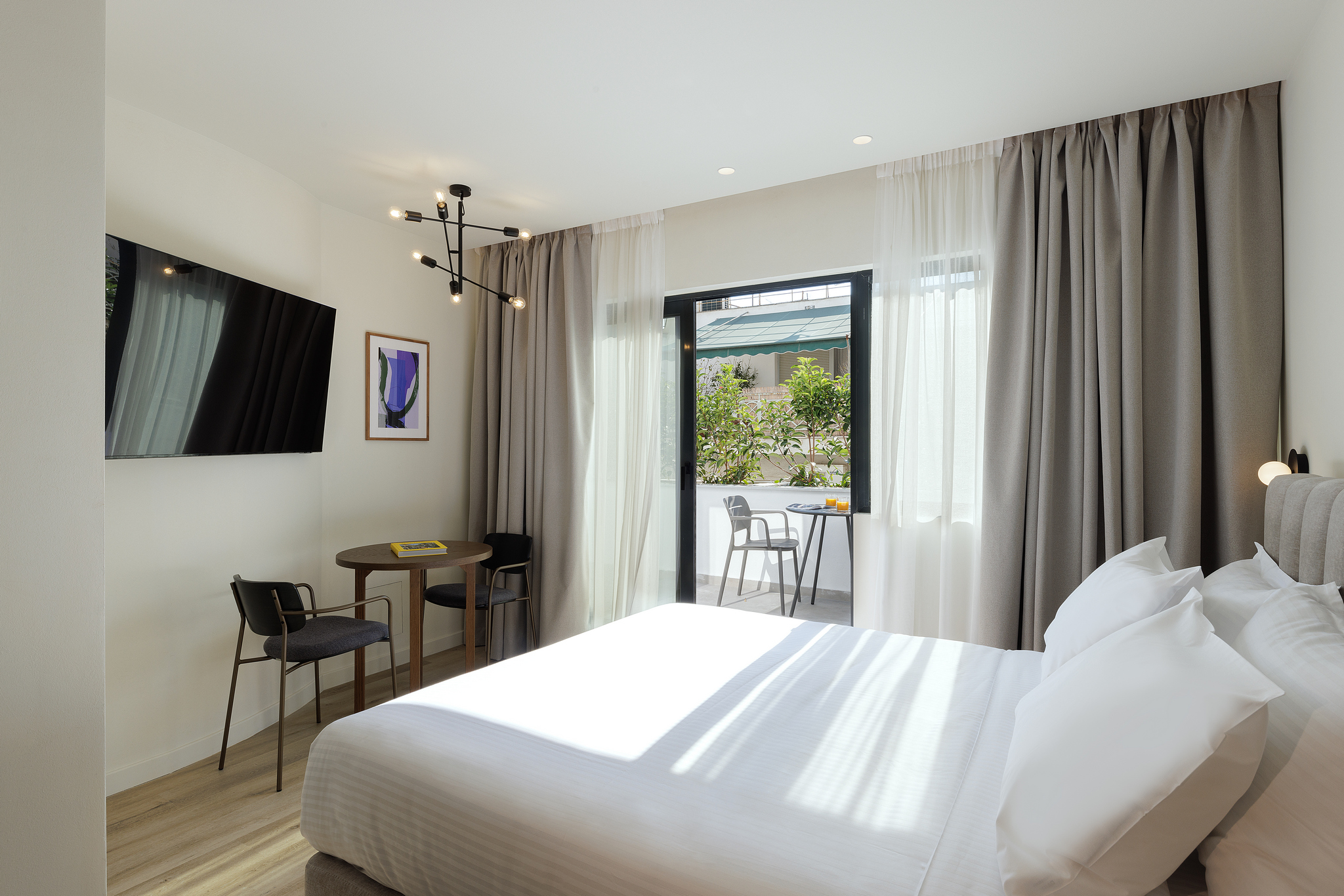 Relaxing bedroom area in the Studio with Balcony at master Plaka Athens, seamlessly connecting to a private outdoor retreat.