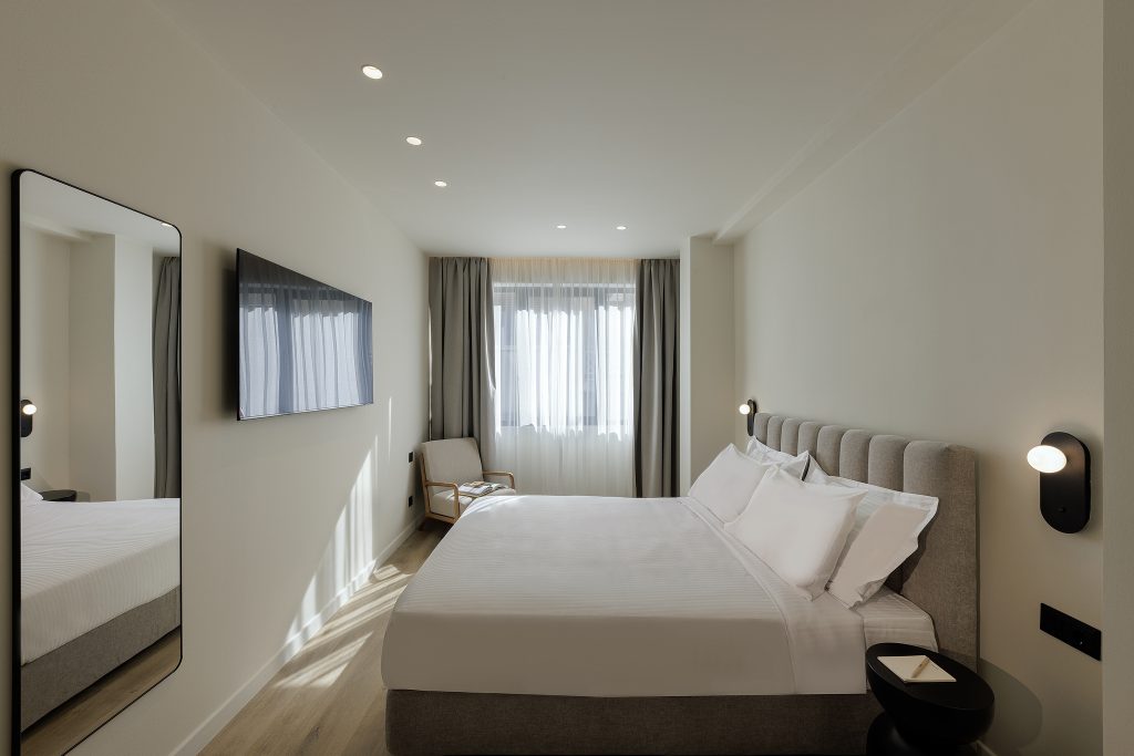 Comfortable sleeping area in the Studio Apartment at master Plaka Athens, blending warm tones with elegant decor.