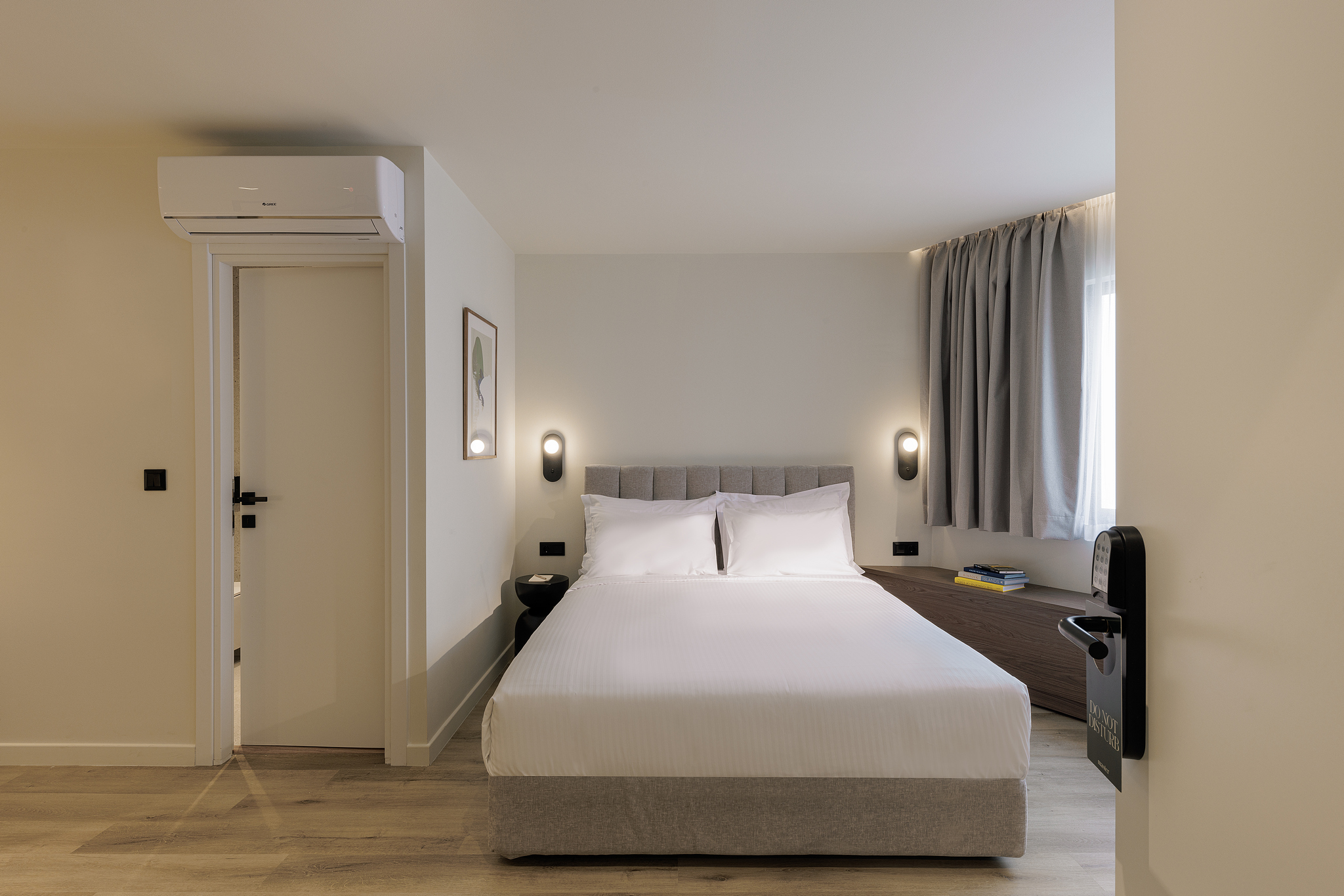 Bright and inviting bedroom in the Family Apartment at master Plaka Athens, featuring a plush bed and stylish furnishings.