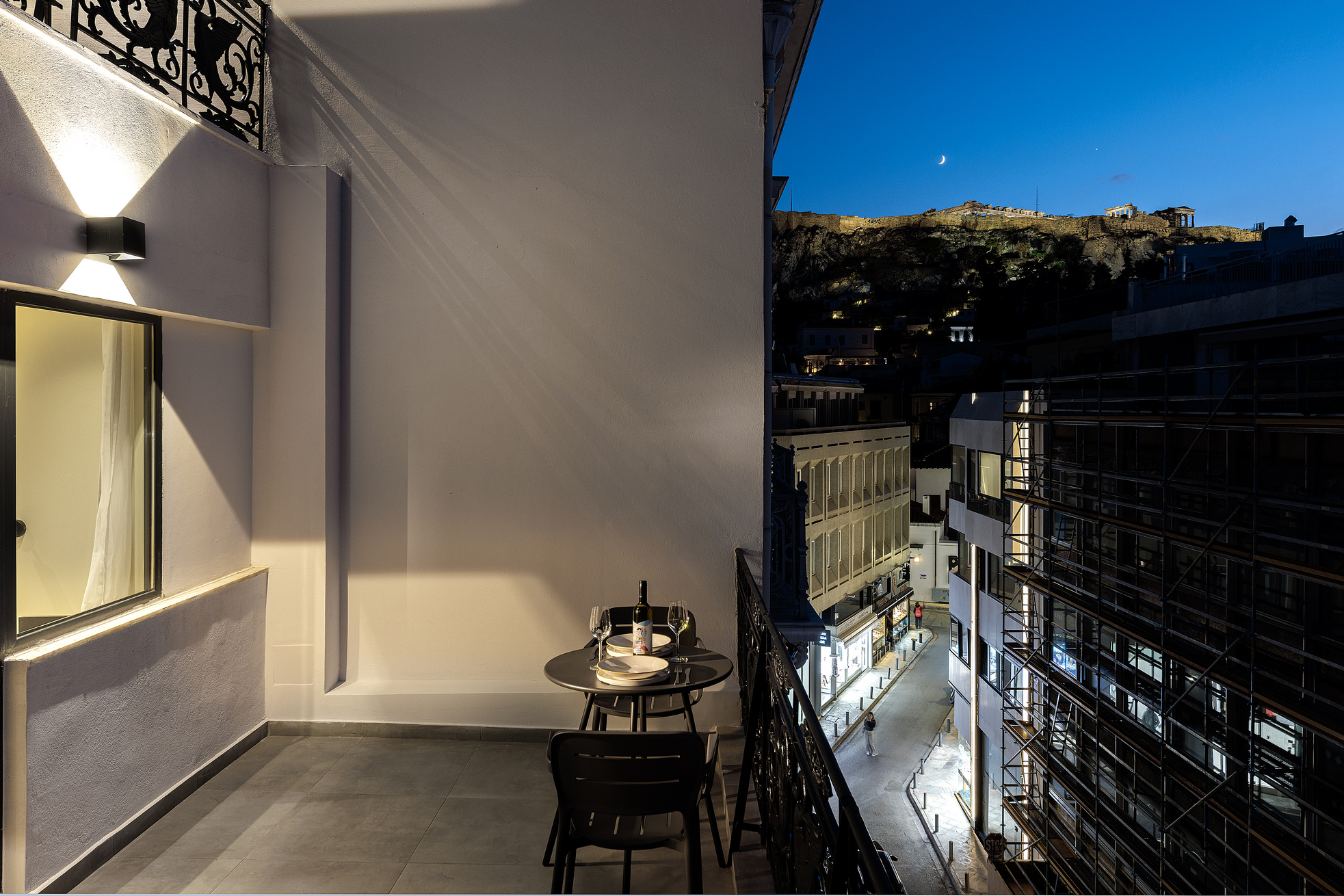 Nighttime view from the Family Room balcony at master Plaka Athens, showcasing the illuminated cityscape of Athens.