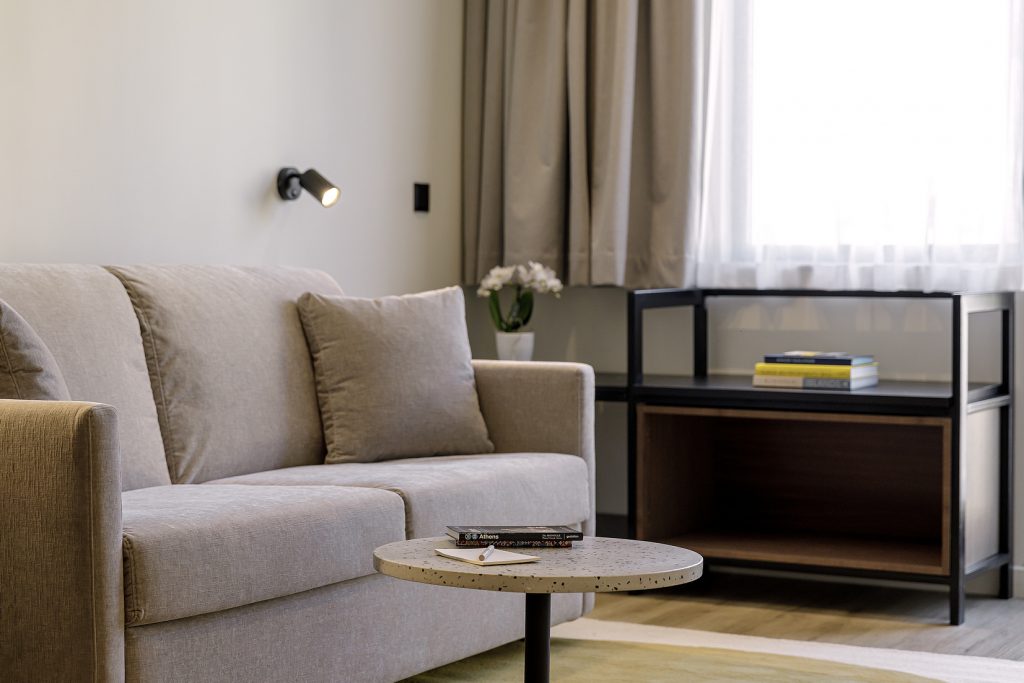 Bright and inviting living space in the One Bedroom Apartment with Balcony at master Plaka Athens, designed with a comfortable sofa for relaxation.