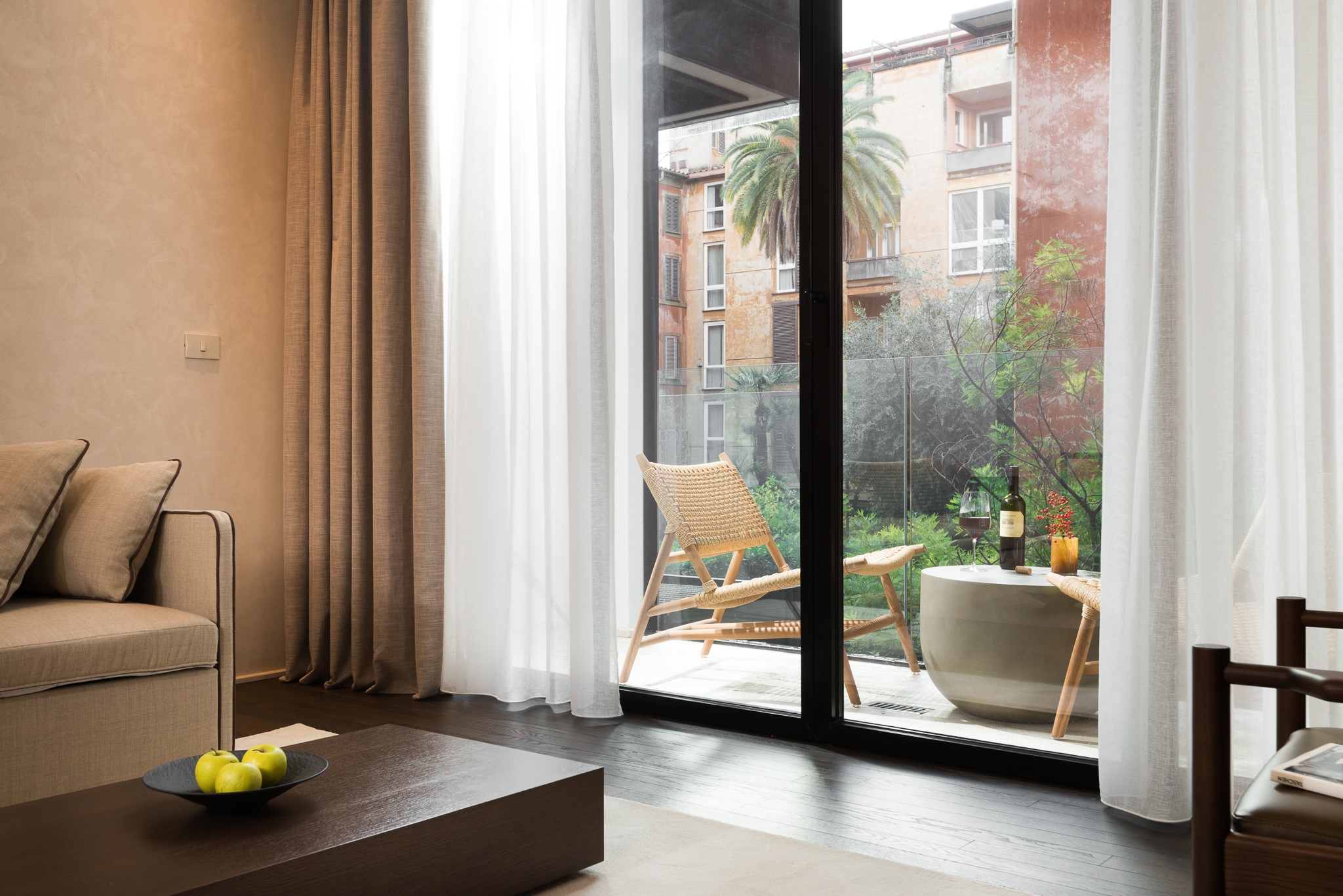 Spacious living area in the Large Studio with Balcony at master Trevi Rome, offering a seamless connection to the balcony with scenic city views.