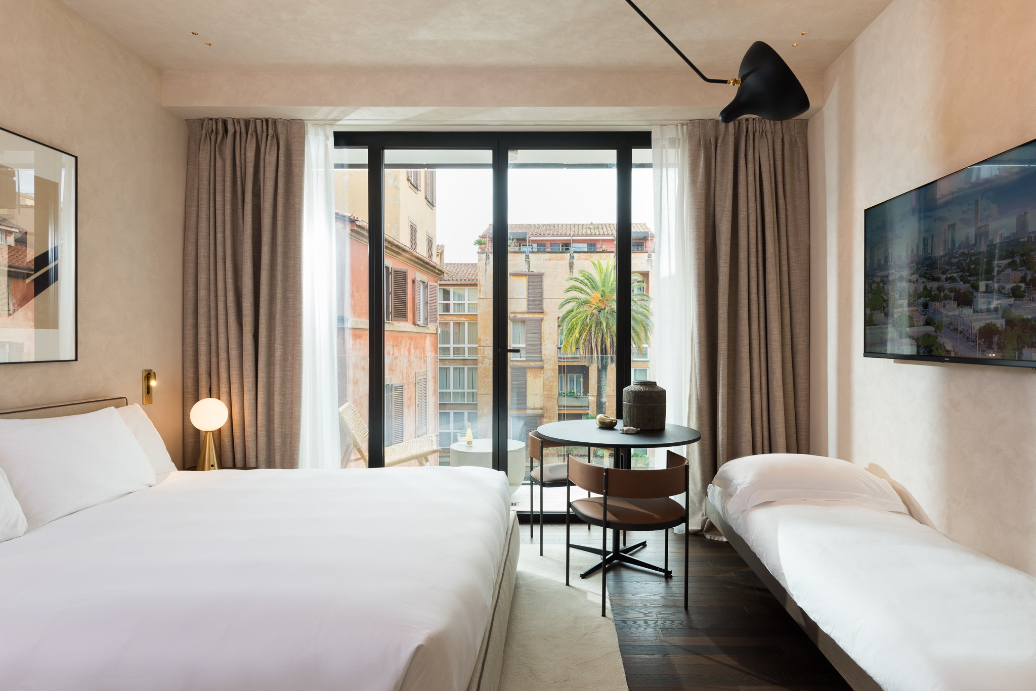 Elegant bedroom in the Family Apartment with Balcony at master Trevi Rome, seamlessly blending cozy decor with a private outdoor retreat.