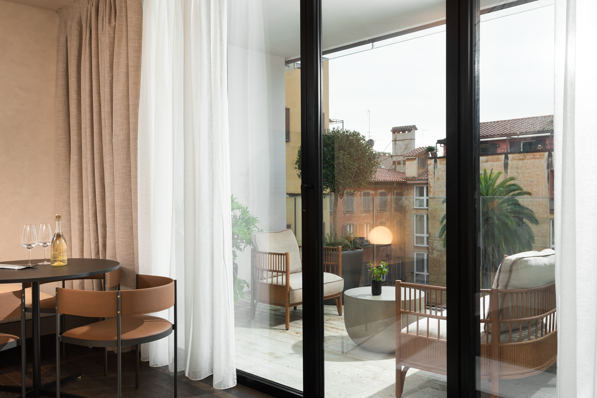 Spacious balcony in the One-Bedroom Apartment with Big Terrace at master Trevi Rome, as seen from inside the apartment, offering a seamless indoor-outdoor experience.