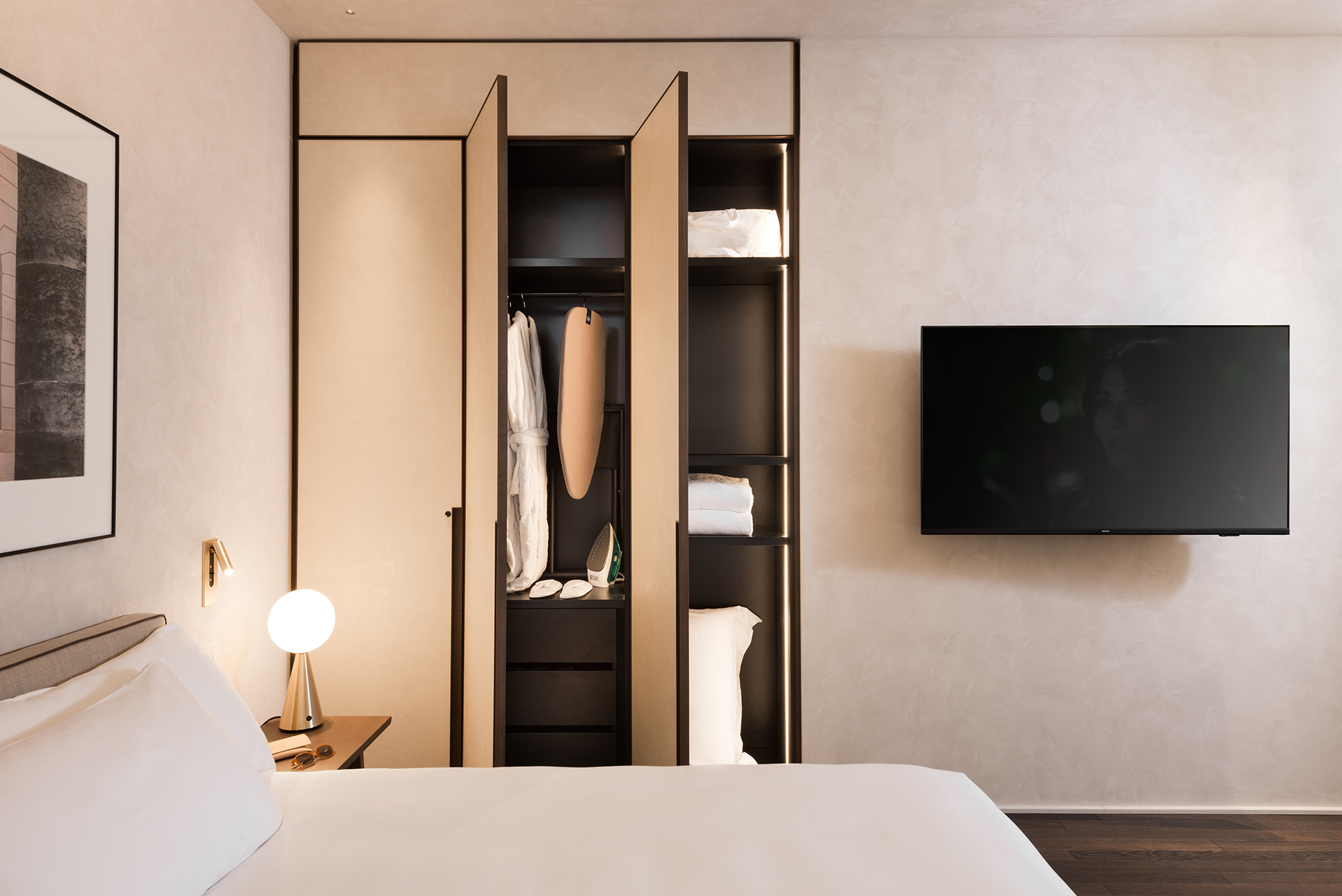 Spacious open closet in the Studio Apartment at master Trevi Rome, featuring organized shelving and hanging space for easy access.