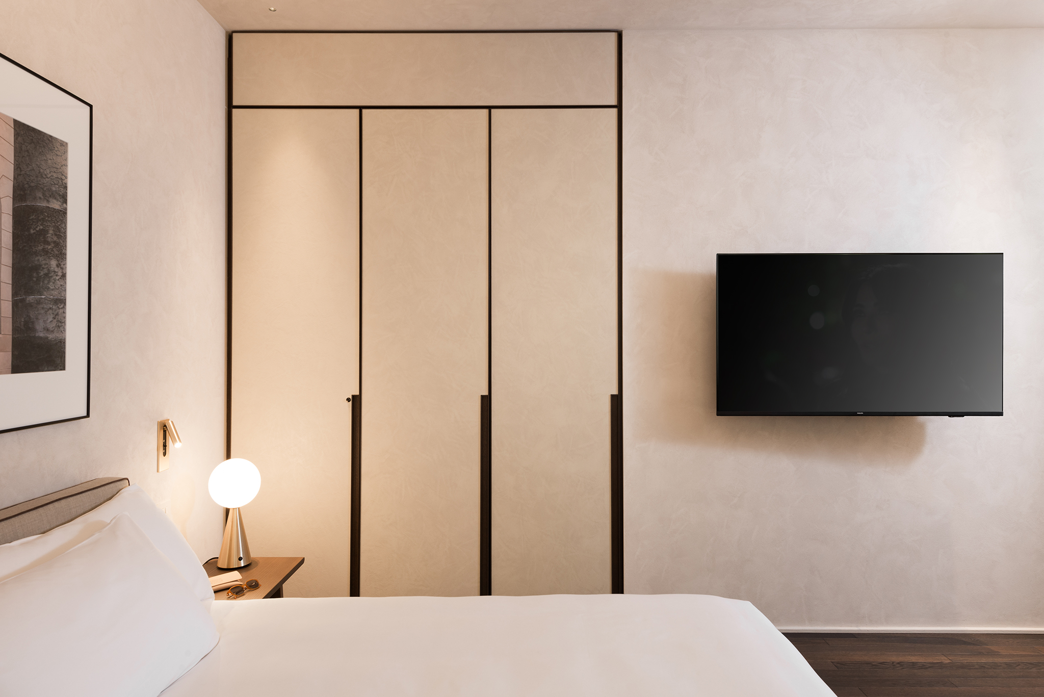 Minimalist closed closet in the Studio Apartment at master Trevi Rome, offering ample storage space with a clean and modern design