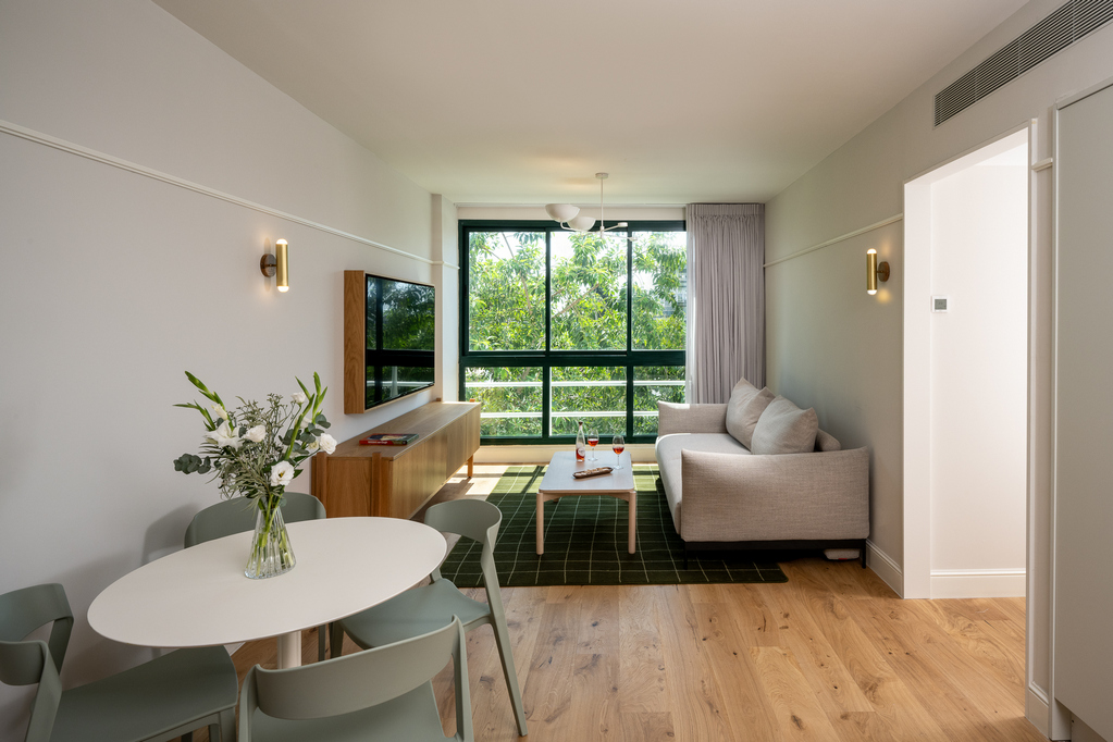 Bright and stylish living space in the Two-Bedroom with Sofa Bed at master Mazeh Tel Aviv, designed for comfort with elegant furnishings.