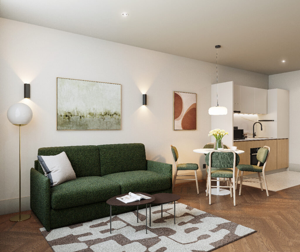 Modern living room featuring a green sofa, round dining table, and fully equipped kitchenette in the one bedroom apartment at master Wola Warsaw.