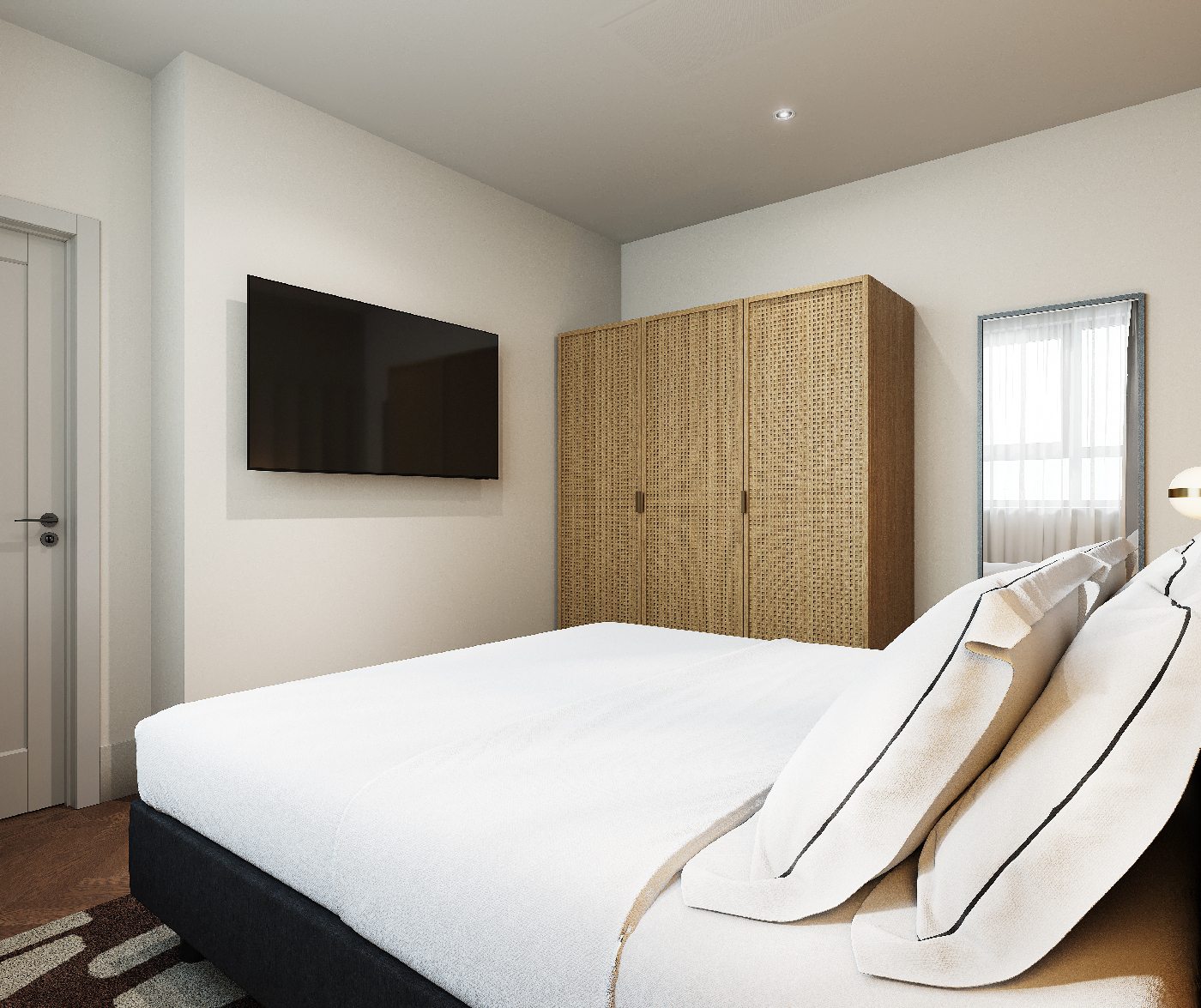 Bedroom interior with wall-mounted smart TV, large wardrobe, and cozy bedding in the one bedroom apartment at master Wola Warsaw.