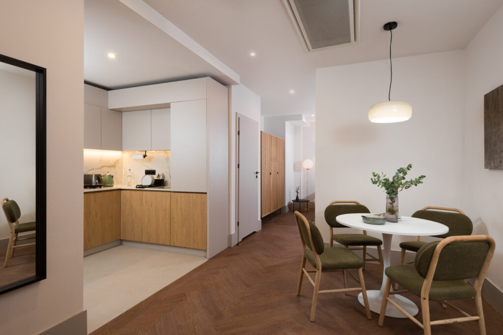 Open-plan kitchenette and dining area in a studio apartment at master Wola Serviced Apartments