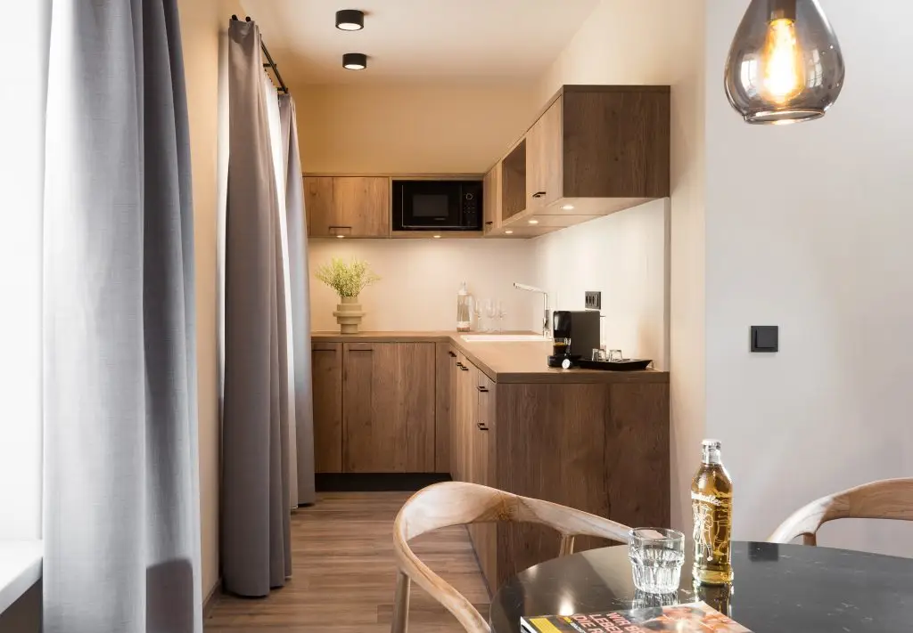 Fully equipped kitchen in a one-bedroom apartment at master Linzergasse, offering modern appliances and a functional layout.
