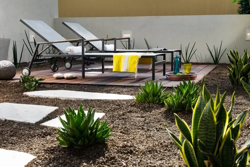 Well-designed outdoor space in the Five-Bedroom Duplex Garden at master Shenkin Tel Aviv, offering a cozy seating area surrounded by greenery.