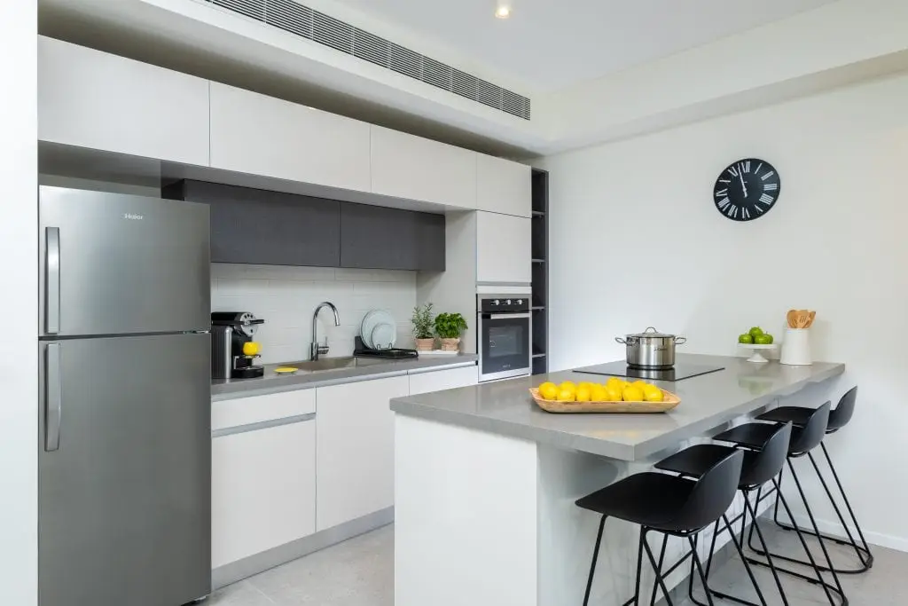 Compact and functional kitchenette in the Two-Bedroom Apartment at master Shenkin Tel Aviv, designed for convenience with modern appliances.