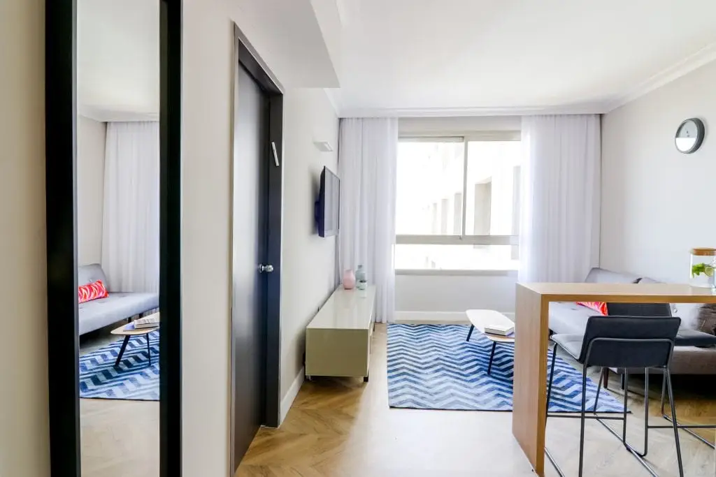 Spacious living area in the One-Bedroom Seaview Apartment at master Haifa, designed with modern furnishings and a relaxing atmosphere.