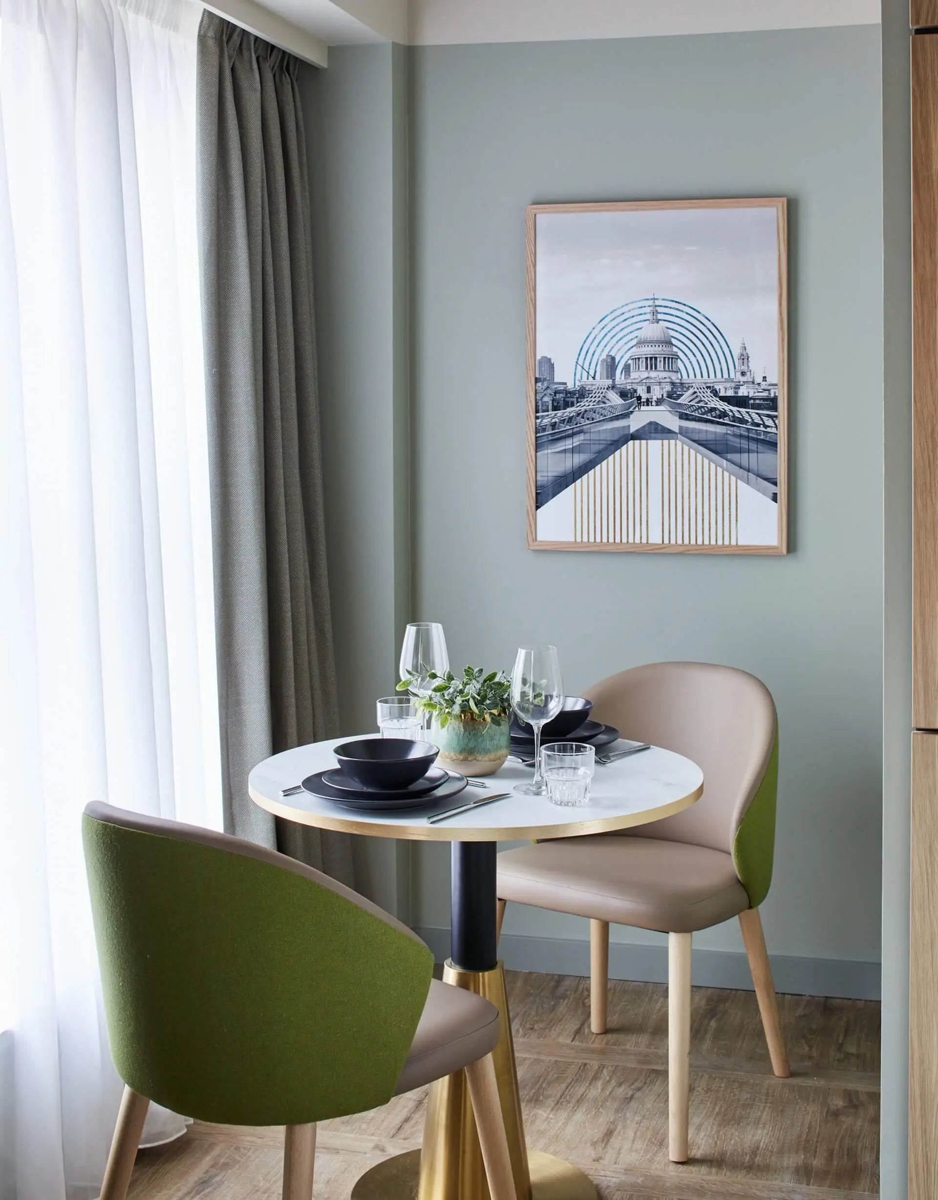 Modern dining area in the Studio at master St. Paul’s London, featuring a sleek table and two chairs for a comfortable meal space.