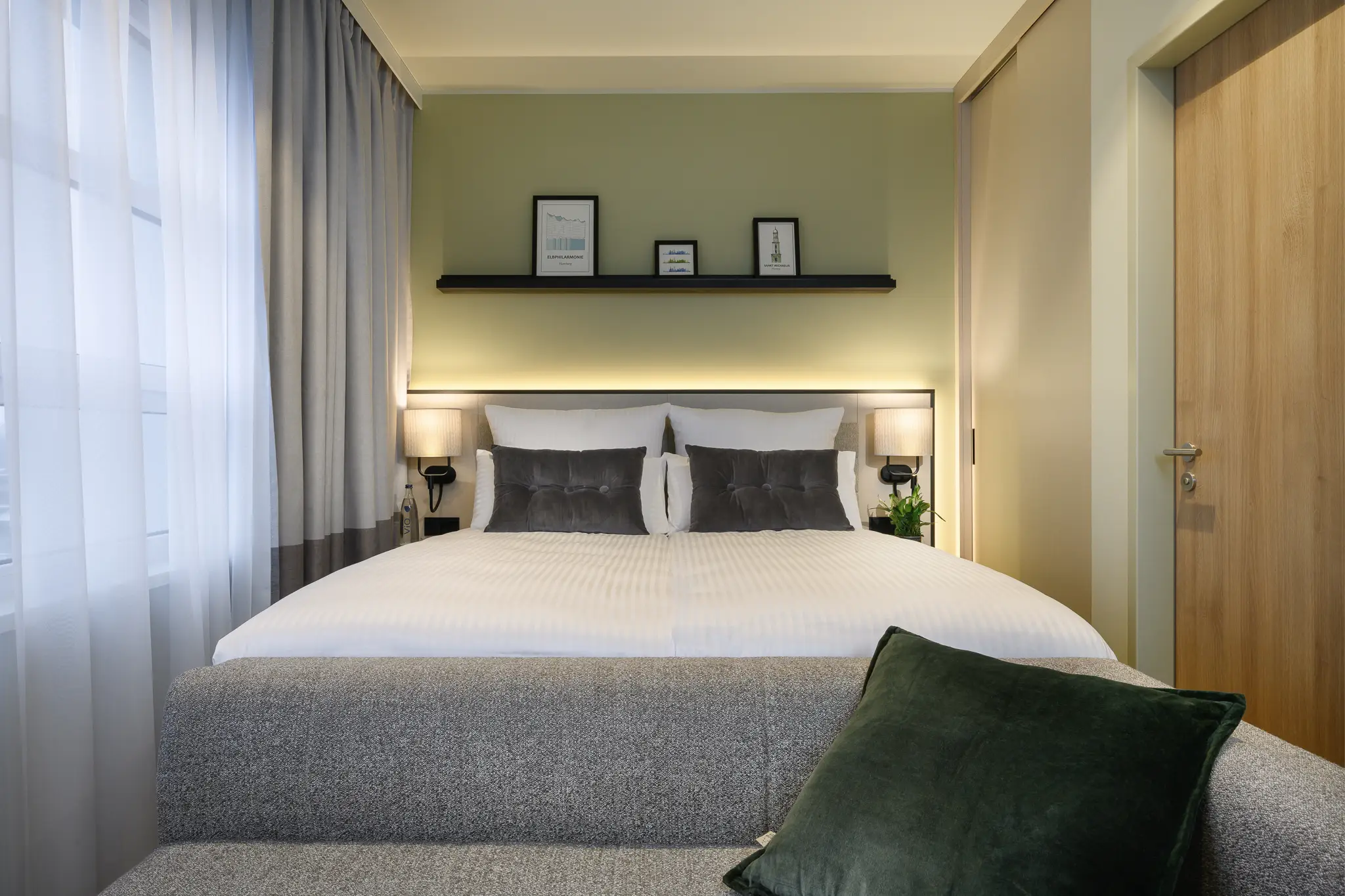 "Comfortable sleeping area in the Studio at master Altona Hamburg, featuring a plush bed and a modern, inviting atmosphere