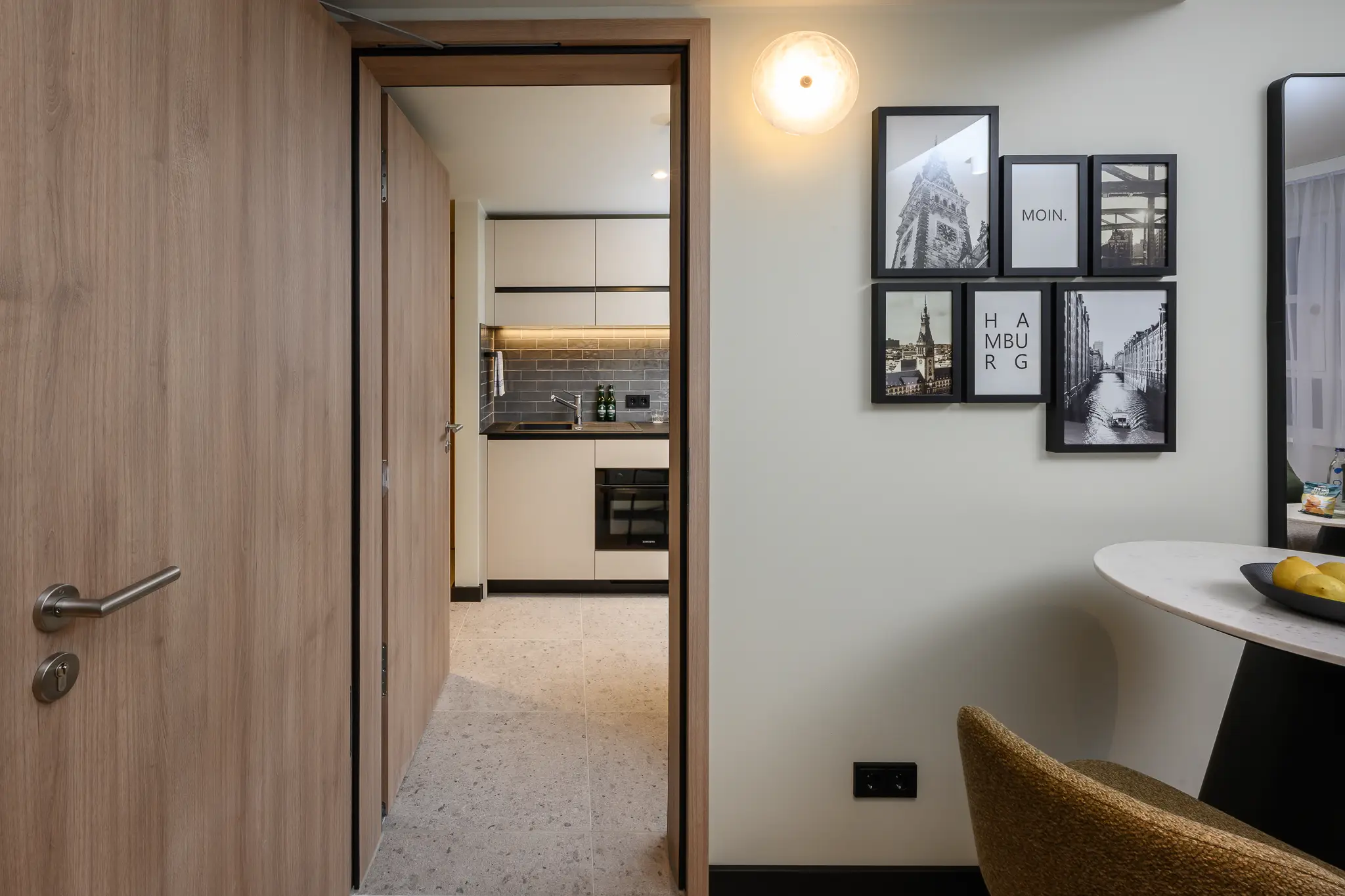 View from the bedroom in the Family Apartment at master Altona Hamburg, showcasing a door leading to the modern kitchen