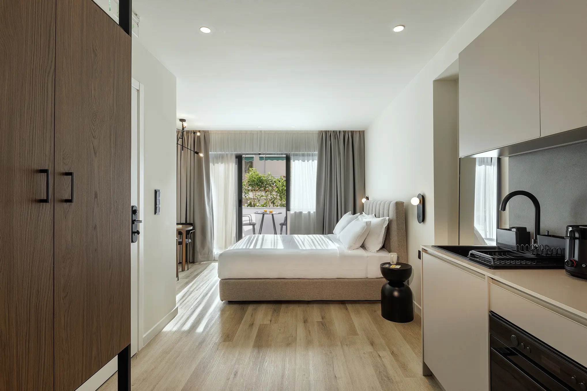 Comfortable bed in the Studio with Balcony at master Plaka Athens, offering direct access to a private balcony with city views.