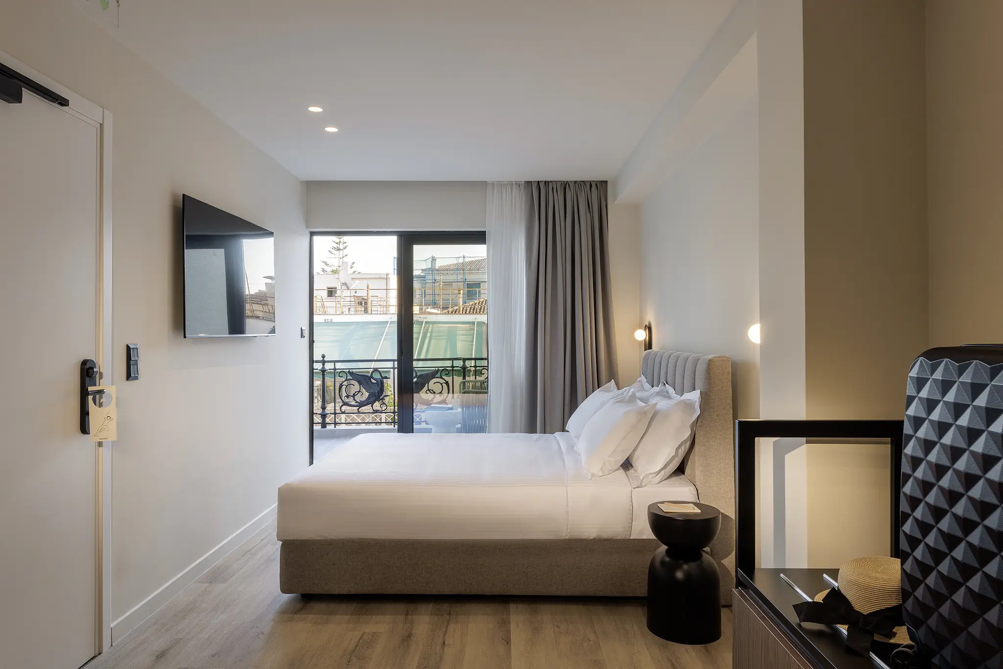 Well-designed Studio with Balcony at master Plaka Athens, where the bed faces an inviting outdoor space with scenic views.