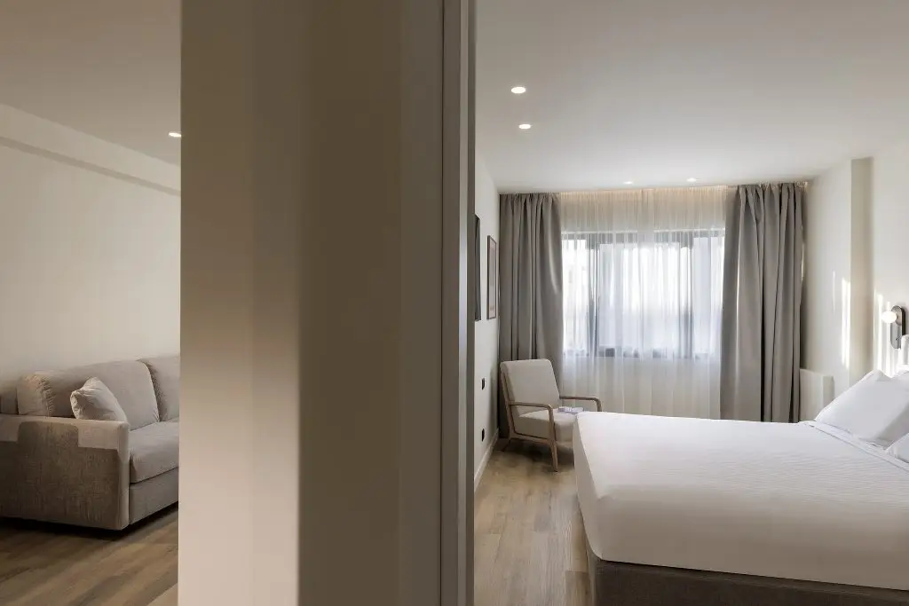 Cozy bedroom in the One Bedroom Apartment at master Plaka Athens, featuring a plush bed and warm, inviting decor.