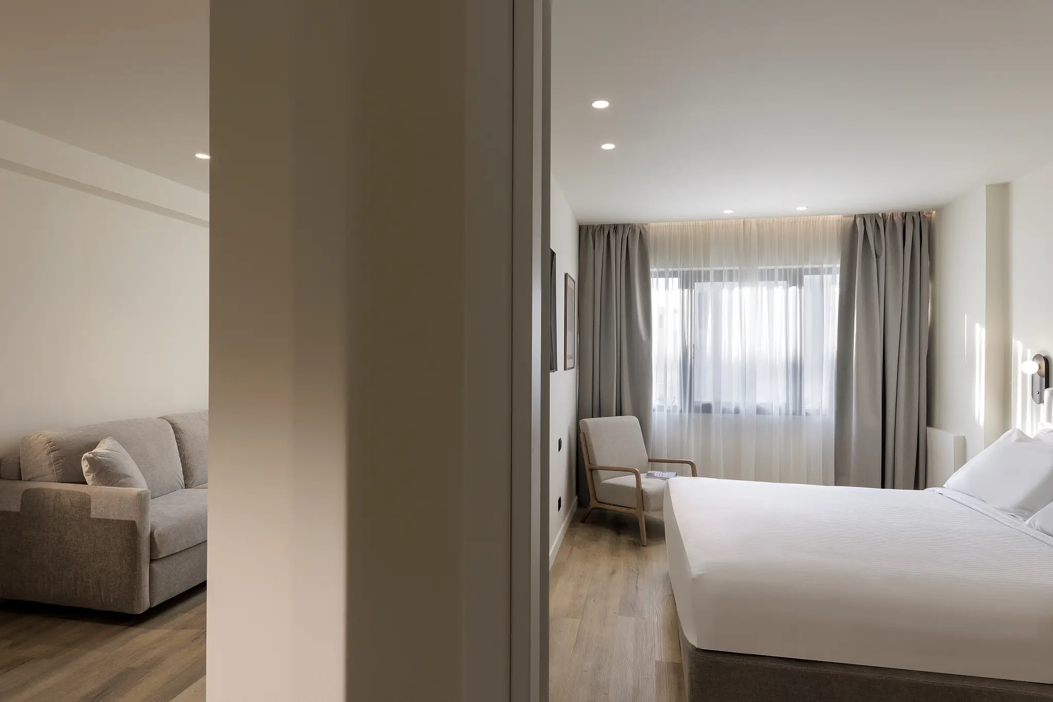 Elegant bedroom in the Family Apartment at master Plaka Athens, designed for comfort with a soft bed and contemporary accents.