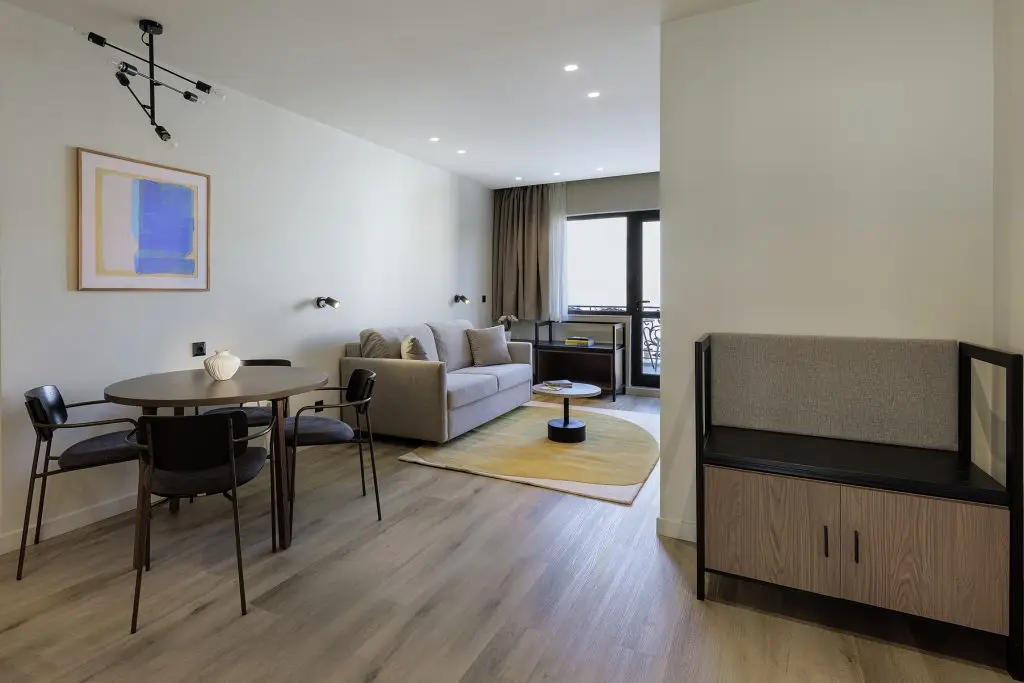 "Stylish seating area in the One Bedroom Apartment with Balcony at master Plaka Athens, featuring a cozy sofa and modern decor.