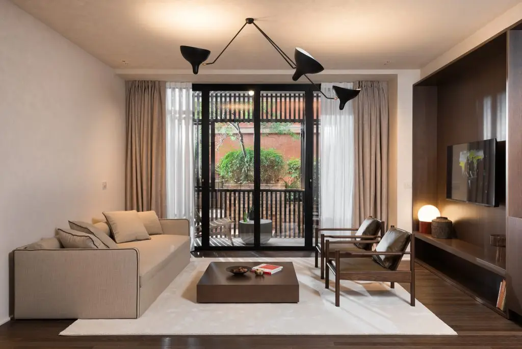 Modern and inviting living area in the Large Studio Ground Level at master Trevi Rome, offering a relaxing atmosphere with views outside.