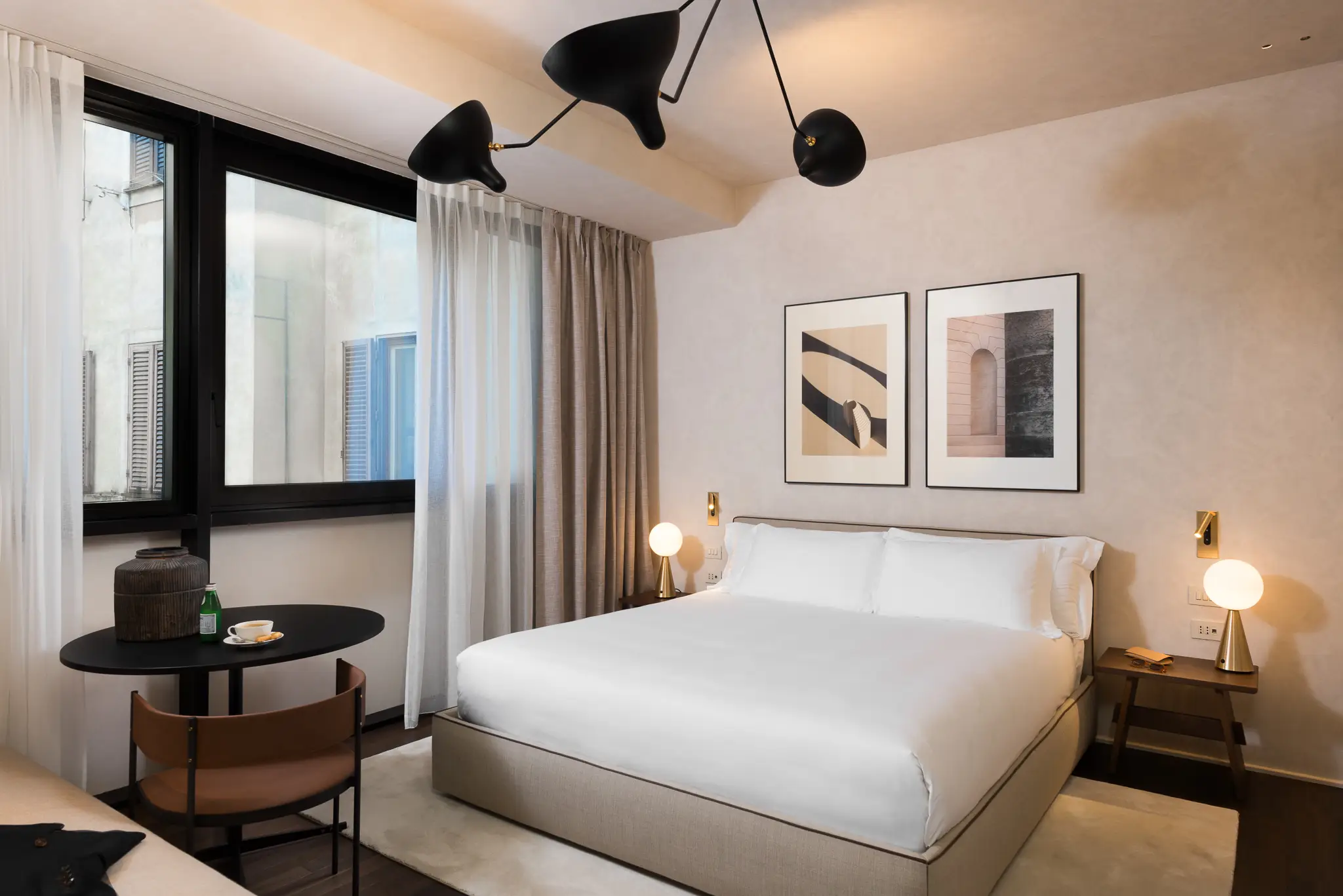 Comfortable bed in the Family Apartment with Balcony at master Trevi Rome, positioned next to a sunlit balcony for a relaxing ambiance.