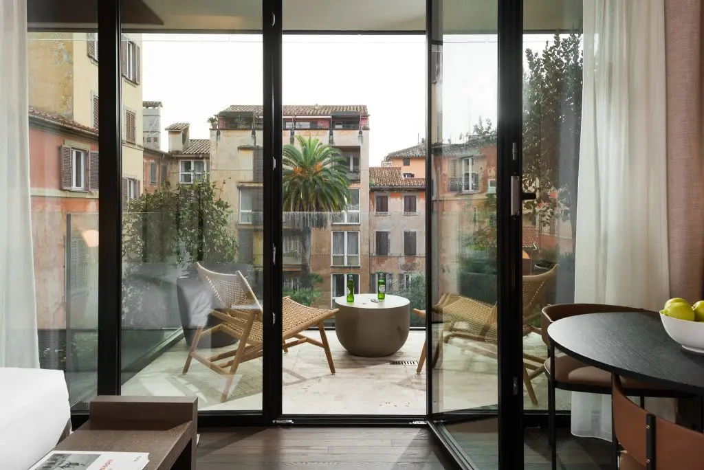 Modern living space in the Studio with Balcony at master Trevi Rome, featuring stylish furnishings and direct access to the balcony.