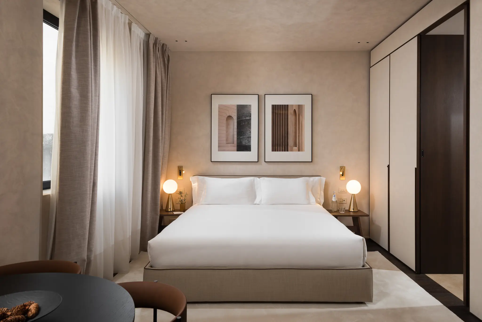 Bright and cozy sleeping area in the Large Studio with Balcony at master Trevi Rome, featuring a plush bed and a modern design.