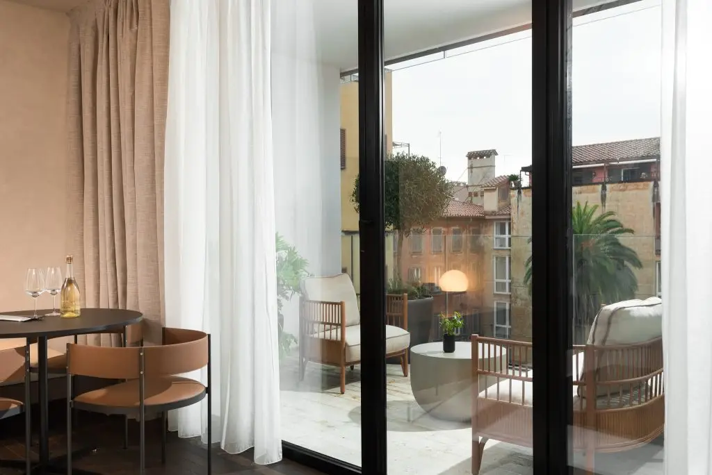 Spacious balcony in the One-Bedroom Apartment with Big Terrace at master Trevi Rome, as seen from inside the apartment, offering a seamless indoor-outdoor experience.