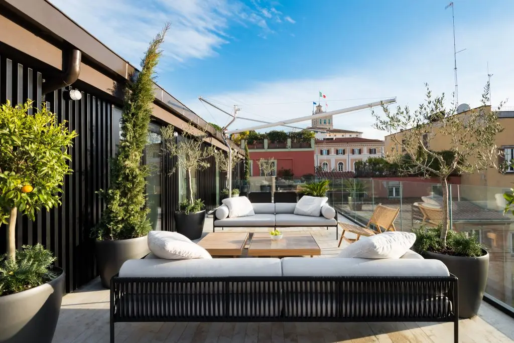 Spacious penthouse terrace at master Trevi Rome, featuring stylish outdoor furniture for a relaxing experience.