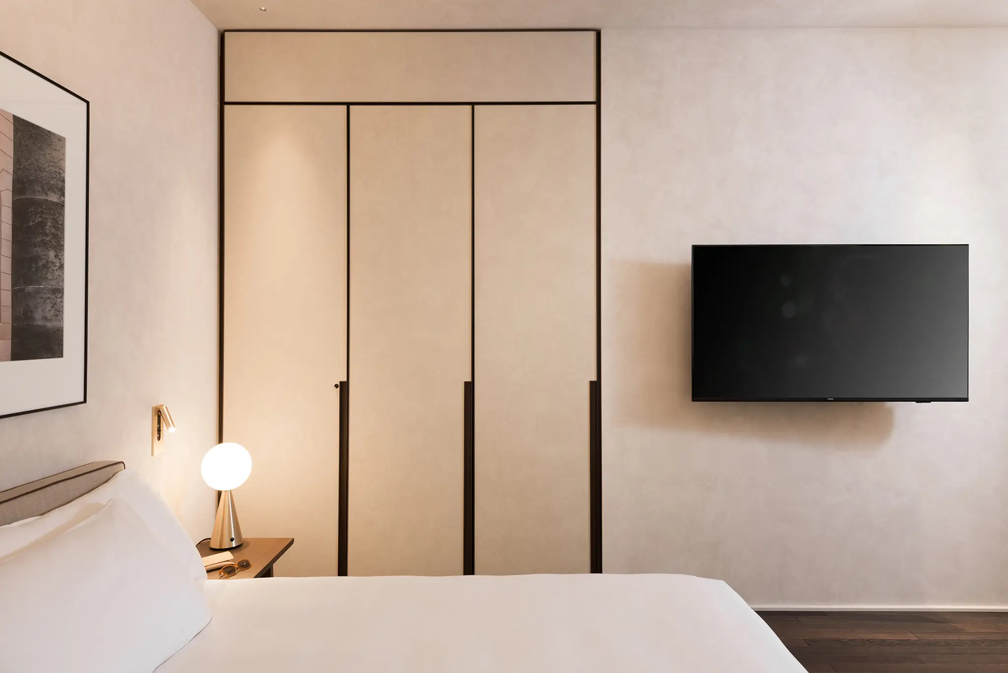 Minimalist closed closet in the Studio Apartment at master Trevi Rome, offering ample storage space with a clean and modern design