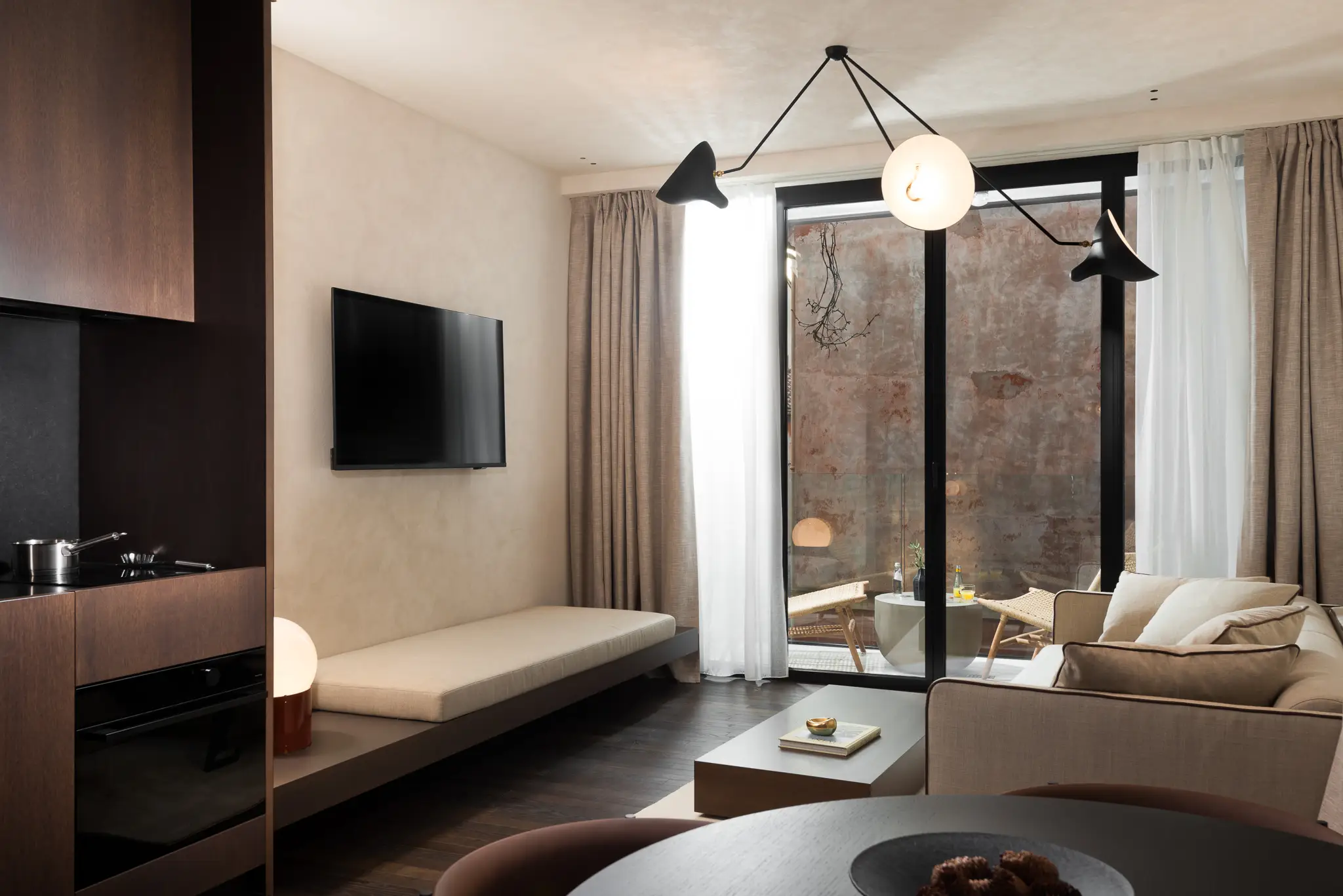 Stylish living space in the Large Studio with Balcony at master Trevi Rome, featuring contemporary furnishings and a view of the balcony.