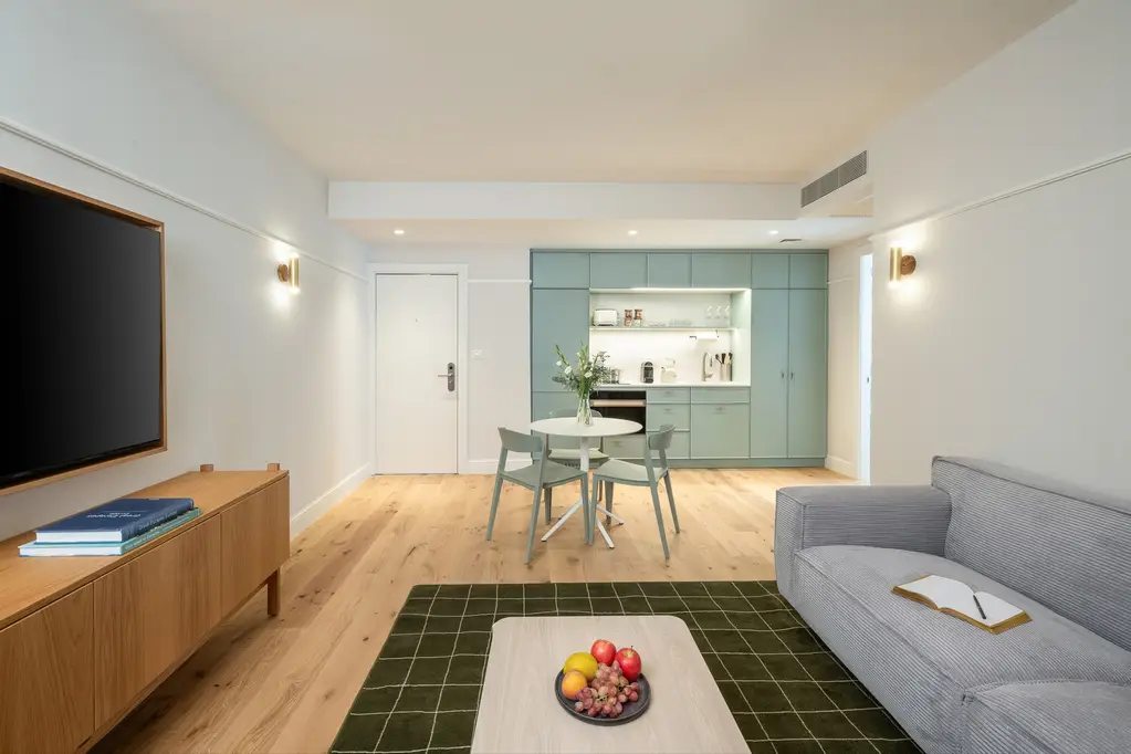 Open-plan kitchen and dining area in the One-Bedroom at master Mazeh Tel Aviv, offering a stylish table for comfortable meals.