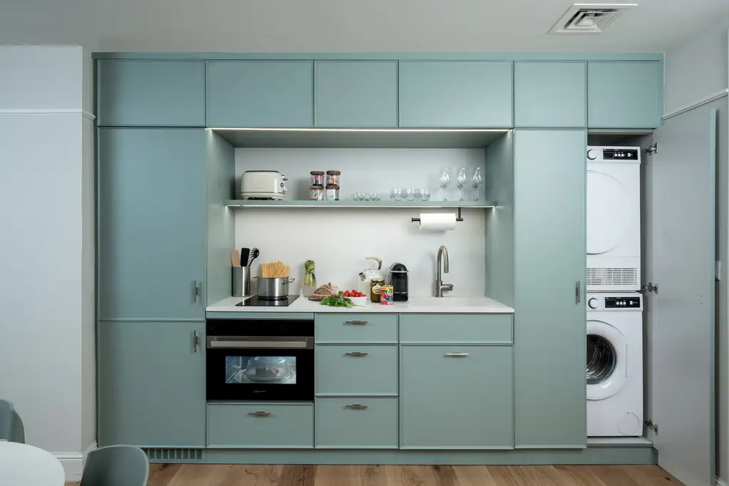 Compact yet functional kitchen in the One-Bedroom at master Mazeh Tel Aviv, designed for convenience with a contemporary layout.